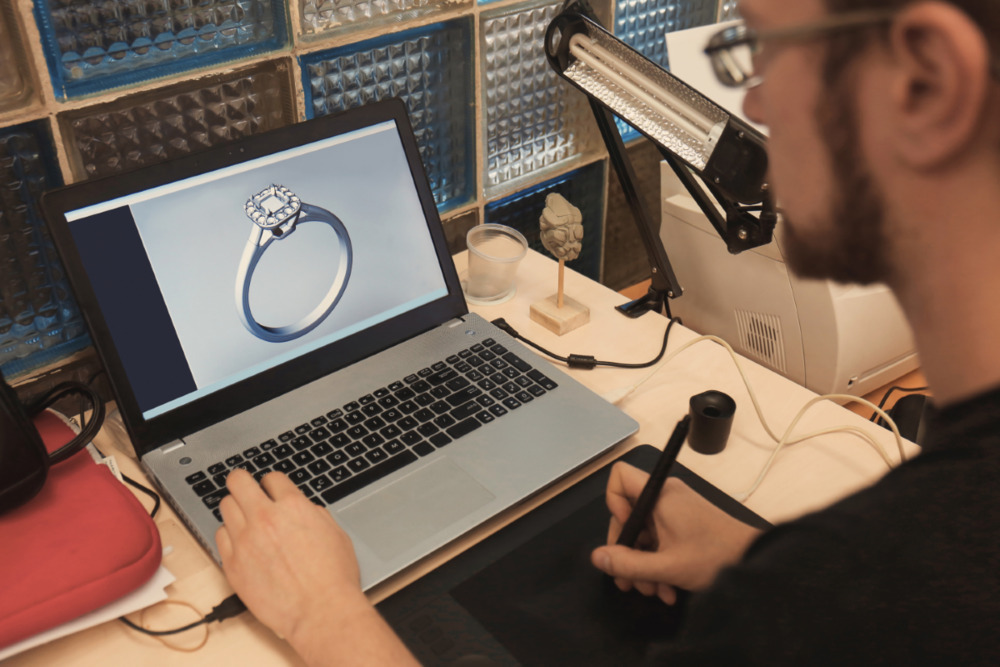 Man designing a ring on his laptop